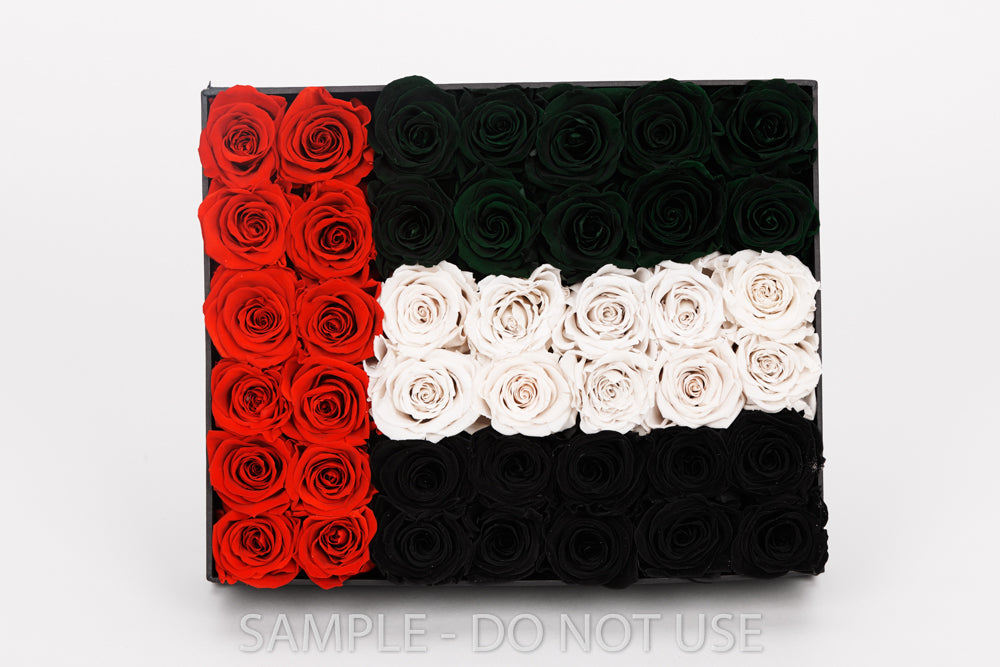 Flag design made with red, white, and black roses on a white background