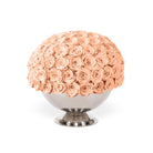 Bouquet of peach roses in a white vase on a white background