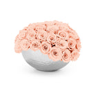 Bouquet of pink roses in a white spherical vase on a white background