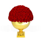 Gold vase with red roses on a white background