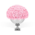Pink roses in a silver vase on a white background