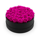 Black box filled with pink roses on a white background